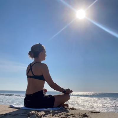 woman-medidating-on-beach